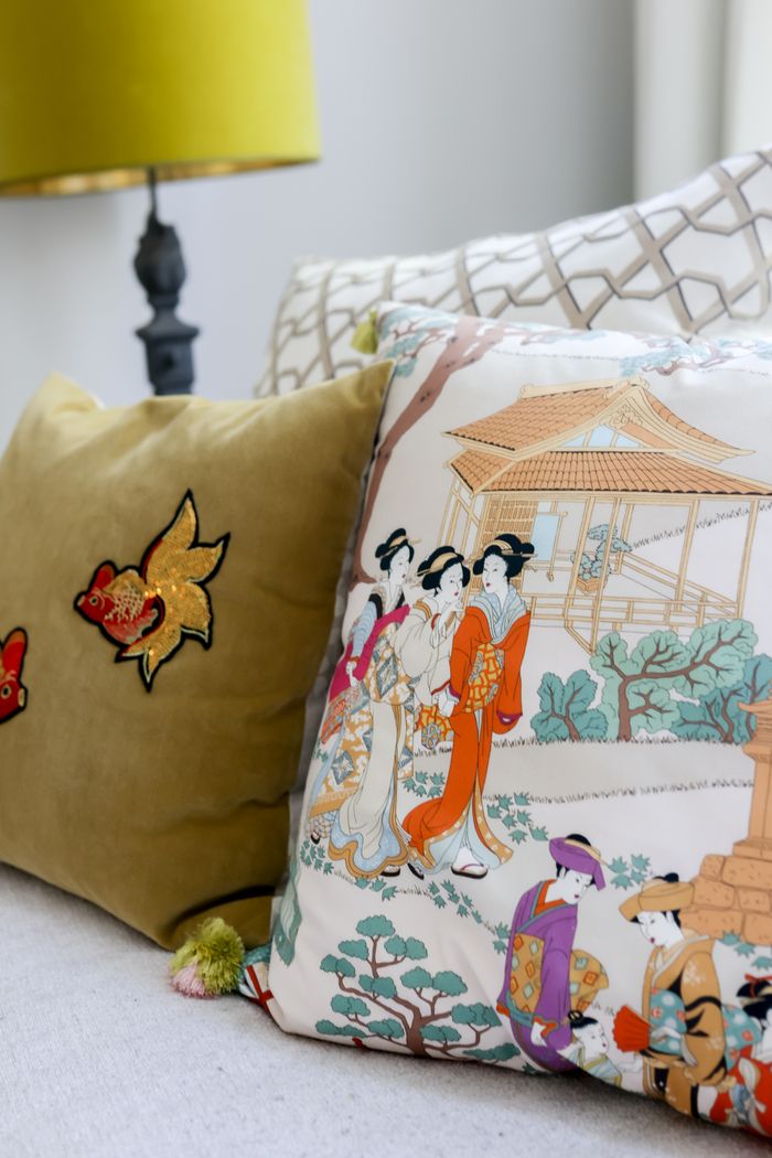 who-we-are Stylish interior with patterned cushions and an Asian motif adding elegance.