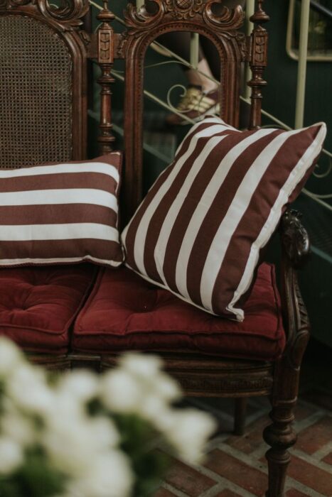 Summer's Blog Elegant vintage chair adorned with striped cushions, adding a touch of classic charm to cozy indoor decor.